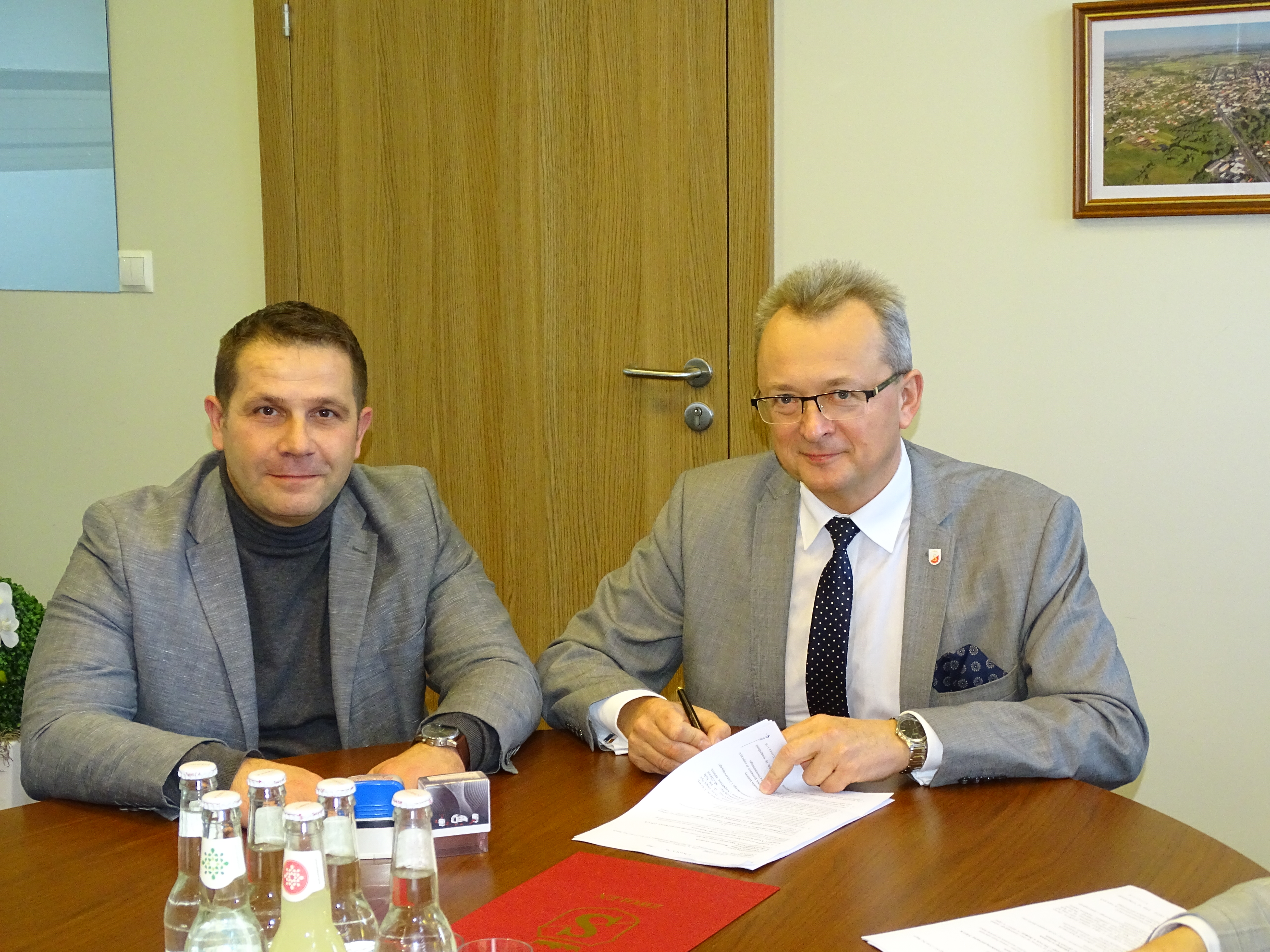 Burmistrz Zwolenia Arkadiusz Sulima (pierwszy z prawej) podpisujący umowę na przebudowę chodników. Na zdjęciu również z-ca burmistrza Grzegorz Molendowski.